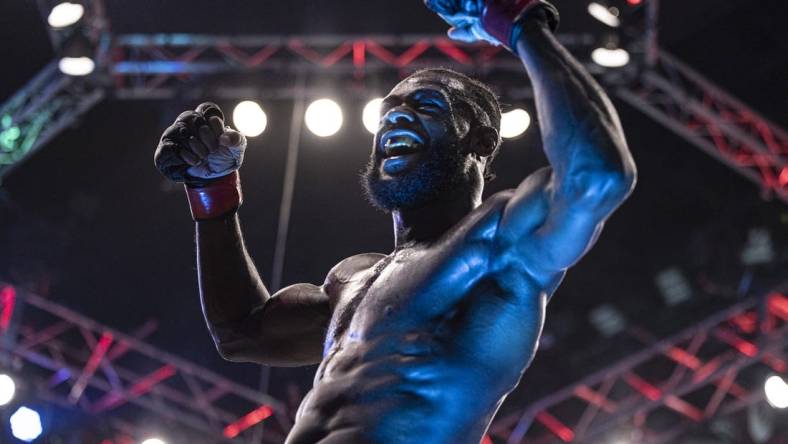 Oct 22, 2022; Abu Dhabi, UAE; Aljamain Sterling (red gloves) celebrates after defeating T.J. Dillashaw (blue gloves) during UFC 280 at Etihad Arena. Mandatory Credit: Craig Kidwell-USA TODAY Sports