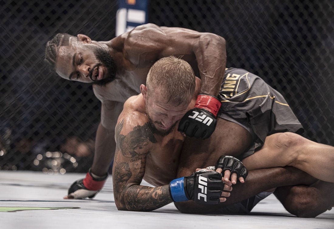 Oct 22, 2022; Abu Dhabi, UAE; Aljamain Sterling (red gloves) and T.J. Dillashaw (blue gloves) during UFC 280 at Etihad Arena. Mandatory Credit: Craig Kidwell-USA TODAY Sports