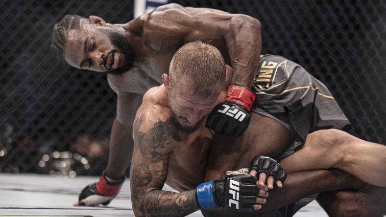 Oct 22, 2022; Abu Dhabi, UAE; Aljamain Sterling (red gloves) and T.J. Dillashaw (blue gloves) during UFC 280 at Etihad Arena. Mandatory Credit: Craig Kidwell-USA TODAY Sports