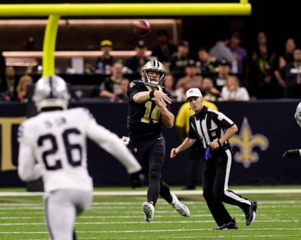 Oct 30, 2022; New Orleans, Louisiana, USA;  New Orleans Saints quarterback Andy Dalton (14) is chased out the pocket and passes downfield against Las Vegas Raiders cornerback Rock Ya-Sin (26) during the second half at Caesars Superdome. Mandatory Credit: Stephen Lew-USA TODAY Sports