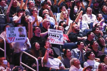Nov 5, 2022; San Francisco, California, USA; Fans hold signs for T1 mid laner Lee "Faker" Sang-hyeok (not pictured) during the League of Legends World Championships against DRX at Chase Center. Mandatory Credit: Kelley L Cox-USA TODAY Sports