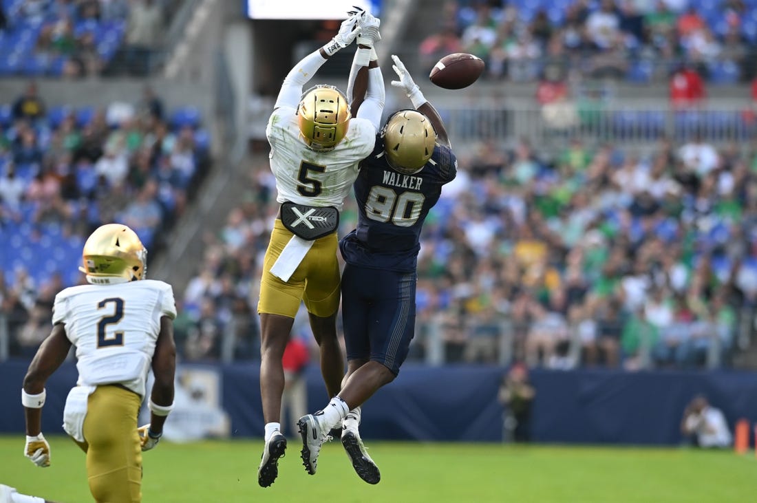 Nov 12, 2022; Baltimore, Maryland, USA;  Notre Dame Fighting Irish cornerback Cam Hart (5) breaks up a pass intended for Navy Midshipmen wide receiver Mark Walker (80) during the second half at M&T Bank Stadium. Mandatory Credit: Tommy Gilligan-USA TODAY Sports