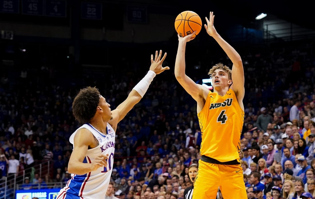 Nov 10, 2022; Lawrence, Kansas, USA; North Dakota State Bison forward Grant Nelson (4) shoots against Kansas Jayhawks forward Jalen Wilson (10) during the first half at Allen Fieldhouse. Mandatory Credit: Jay Biggerstaff-USA TODAY Sports