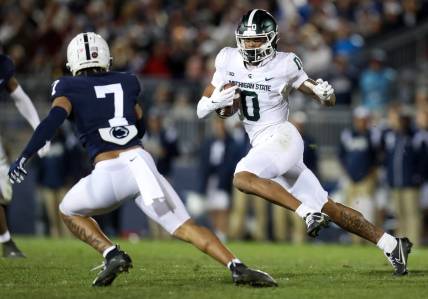 Nov 26, 2022; University Park, Pennsylvania, USA; Michigan State Spartans wide receiver Keon Coleman (0) runs the ball against Penn State Nittany Lions safety Jaylen Reed (7) during the fourth quarter at Beaver Stadium. Penn State won 35-16. Mandatory Credit: Matthew OHaren-USA TODAY Sports