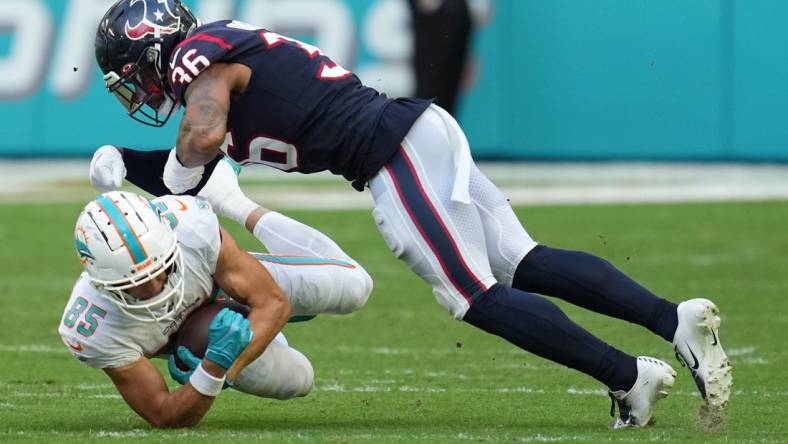 Miami Dolphins wide receiver River Cracraft (85) hauls in a catch as Houston Texans safety Jonathan Owens (36) closes in for the tackle during the first half of an NFL game at Hard Rock Stadium in Miami Gardens, Nov. 27, 2022.