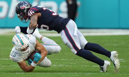 Miami Dolphins wide receiver River Cracraft (85) hauls in a catch as Houston Texans safety Jonathan Owens (36) closes in for the tackle during the first half of an NFL game at Hard Rock Stadium in Miami Gardens, Nov. 27, 2022.