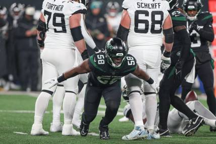Dec 22, 2022; East Rutherford, New Jersey, USA; New York Jets defensive end Carl Lawson (58) celebrates a defensive stop during the first half against the Jacksonville Jaguars at MetLife Stadium. Mandatory Credit: Vincent Carchietta-USA TODAY Sports