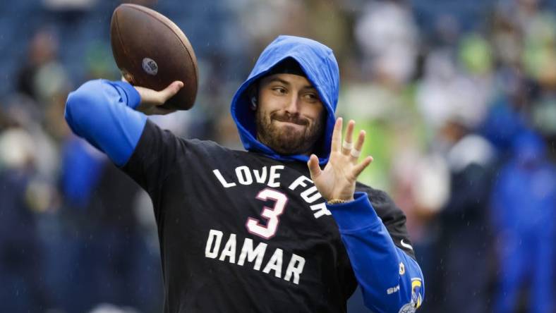 Jan 8, 2023; Seattle, Washington, USA; Los Angeles Rams quarterback Baker Mayfield (17) participates in early pregame warmups against the Seattle Seahawks while wearing a    Love for Damar    t-shirt in honor of Buffalo Bills safety Damar Hamlin (3, not pictured) at Lumen Field. Mandatory Credit: Joe Nicholson-USA TODAY Sports