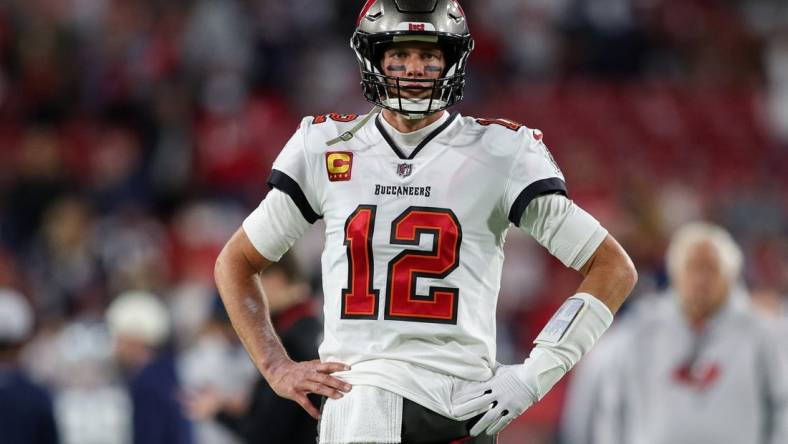 Jan 16, 2023; Tampa, Florida, USA; Tampa Bay Buccaneers quarterback Tom Brady (12) looks on before a  wild card game against the Dallas Cowboys at Raymond James Stadium. Mandatory Credit: Nathan Ray Seebeck-USA TODAY Sports