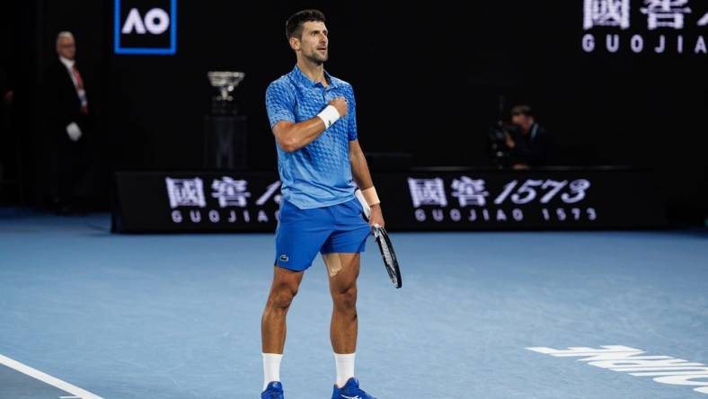 Jan 29, 2023; Melbourne, Victoria, Australia; Novak Djokovic of Serbia celebrates his victory over Stefanos Tsitsipas of Greece in the men's final on day fourteen of the 2023 Australian Open tennis tournament at Melbourne Park. Mandatory Credit: Mike Frey-USA TODAY Sports