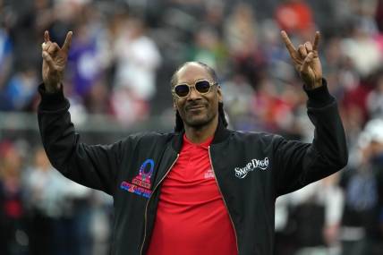 Feb 5, 2023; Paradise, Nevada, USA; AFC captain and recording artist Snoop Dogg watches from the sidelines against the NFC during the Pro Bowl Games at Allegiant Stadium. Mandatory Credit: Kirby Lee-USA TODAY Sports