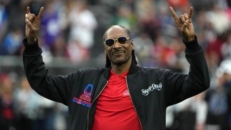 Feb 5, 2023; Paradise, Nevada, USA; AFC captain and recording artist Snoop Dogg watches from the sidelines against the NFC during the Pro Bowl Games at Allegiant Stadium. Mandatory Credit: Kirby Lee-USA TODAY Sports