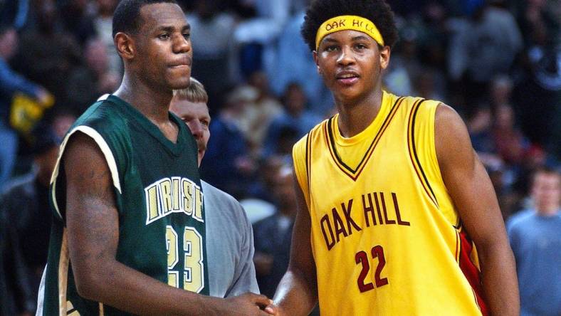 After 19 seasons, Carmelo Anthony retired from the NBA on Monday. Pictured here as a senior at Oak Hill with high school junior LeBron James.