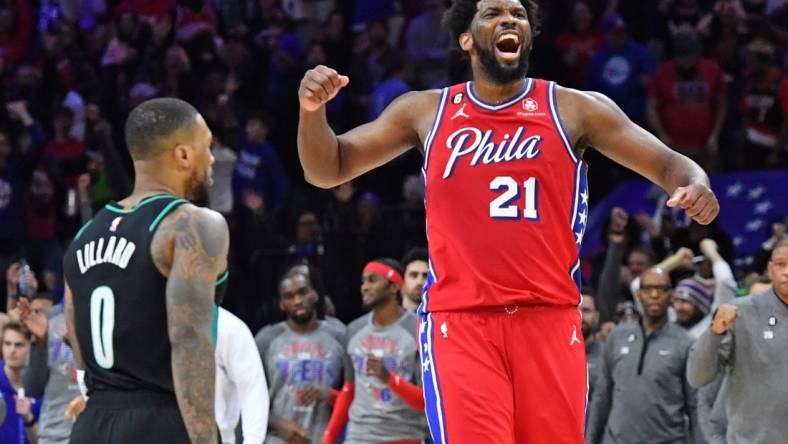 Mar 10, 2023; Philadelphia, Pennsylvania, USA; Philadelphia 76ers center Joel Embiid (21) celebrates win over Portland Trail Blazers guard Damian Lillard (0) at Wells Fargo Center. Mandatory Credit: Eric Hartline-USA TODAY Sports