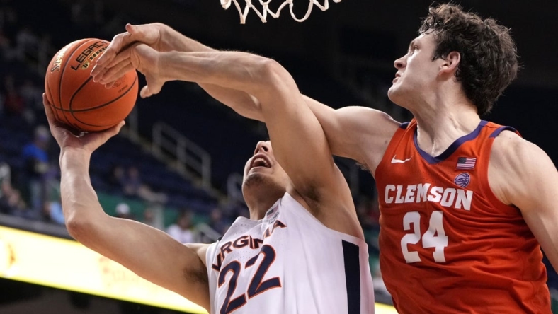 Mar 10, 2023; Greensboro, NC, USA;  Virginia Cavaliers center Francisco Caffaro (22) shoots as Clemson Tigers center PJ Hall (24) defends in the second half during the semifinals of the ACC Tournament at Greensboro Coliseum. Mandatory Credit: Bob Donnan-USA TODAY Sports