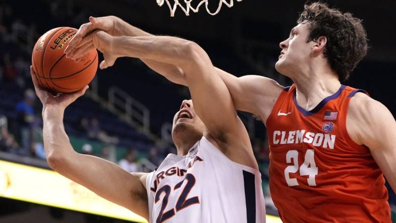 Mar 10, 2023; Greensboro, NC, USA;  Virginia Cavaliers center Francisco Caffaro (22) shoots as Clemson Tigers center PJ Hall (24) defends in the second half during the semifinals of the ACC Tournament at Greensboro Coliseum. Mandatory Credit: Bob Donnan-USA TODAY Sports