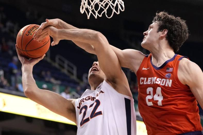Mar 10, 2023; Greensboro, NC, USA;  Virginia Cavaliers center Francisco Caffaro (22) shoots as Clemson Tigers center PJ Hall (24) defends in the second half during the semifinals of the ACC Tournament at Greensboro Coliseum. Mandatory Credit: Bob Donnan-USA TODAY Sports