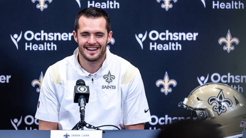 Mar 11, 2023; Metairie, LA, USA;   New Orleans Saints quarterback Derek Carr (4) speaks at Ochsner Sports Performance Center. Mandatory Credit: Stephen Lew-USA TODAY Sports