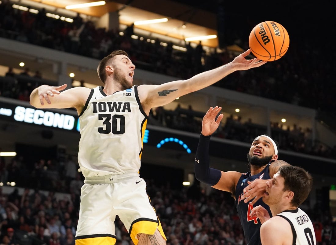 Mar 16, 2023; Birmingham, AL, USA; Iowa Hawkeyes guard Connor McCaffery (30) reaches for a rebound against Auburn Tigers forward Johni Broome (4) during the second half in the first round of the 2023 NCAA Tournament at Legacy Arena. Mandatory Credit: Marvin Gentry-USA TODAY Sports