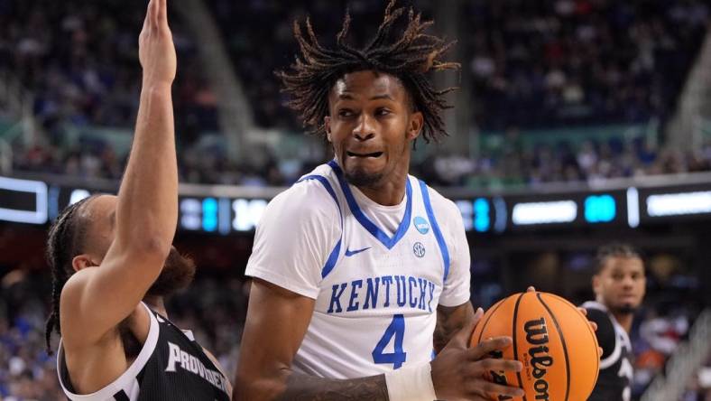 Mar 17, 2023; Greensboro, NC, USA; Kentucky Wildcats forward Daimion Collins (4) controls the ball against Providence Friars guard Jared Bynum (4) in the second half at Greensboro Coliseum. Mandatory Credit: Bob Donnan-USA TODAY Sports