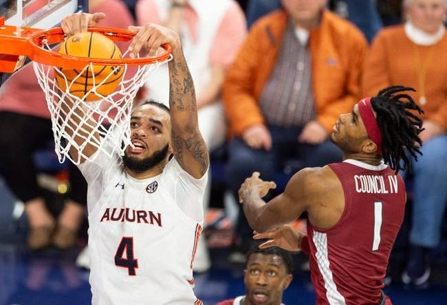 Auburn Tigers forward Johni Broome (4) dunks the ball as Auburn Tigers take on Arkansas Razorbacks at Neville Arena in Auburn, Ala., on Saturday, Jan. 7, 2023. Auburn Tigers defeated Arkansas Razorbacks 72-59.