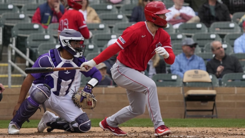 Mar 22, 2023; Salt River Pima-Maricopa, Arizona, USA; Los Angeles Angels first baseman Jared Walsh (20) hits an RBI double against the Colorado Rockies in the fourth inning at Salt River Fields at Talking Stick. Mandatory Credit: Rick Scuteri-USA TODAY Sports