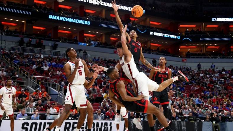 Mar 24, 2023; Louisville, KY, USA; Alabama Crimson Tide guard Mark Sears (1) charges into San Diego State Aztecs guard Lamont Butler (5) during the first half of the NCAA tournament round of sixteen at KFC YUM! Center. Mandatory Credit: Jordan Prather-USA TODAY Sports