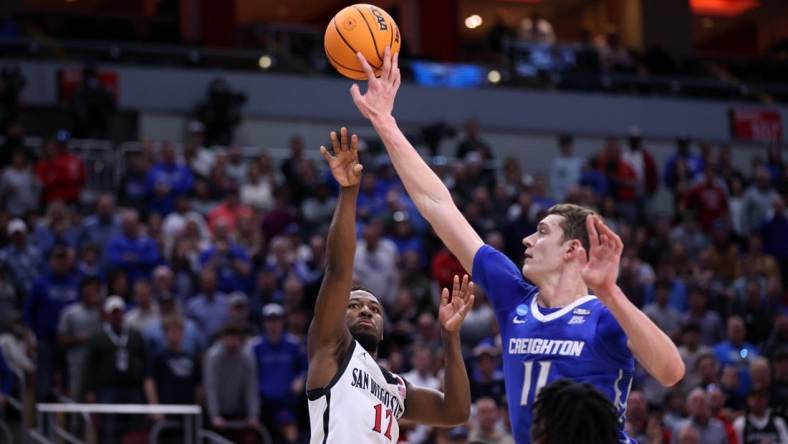 Mar 26, 2023; Louisville, KY, USA;  Creighton Bluejays center Ryan Kalkbrenner (11) blocks a shot at the basket by San Diego State Aztecs guard Darrion Trammell (12) during the second half at the NCAA Tournament South Regional-Creighton vs San Diego State at KFC YUM! Center. Mandatory Credit: Jordan Prather-USA TODAY Sports