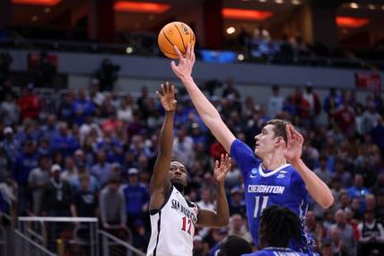 Mar 26, 2023; Louisville, KY, USA;  Creighton Bluejays center Ryan Kalkbrenner (11) blocks a shot at the basket by San Diego State Aztecs guard Darrion Trammell (12) during the second half at the NCAA Tournament South Regional-Creighton vs San Diego State at KFC YUM! Center. Mandatory Credit: Jordan Prather-USA TODAY Sports