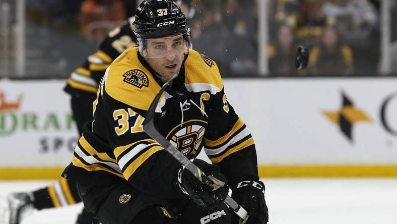 Mar 28, 2023; Boston, Massachusetts, USA; Boston Bruins center Patrice Bergeron (37) eyes a loose puck against the Nashville Predators during the first period at TD Garden. Mandatory Credit: Winslow Townson-USA TODAY Sports