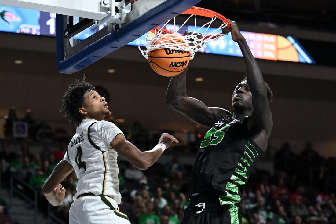 Mar 28, 2023; Las Vegas, Nevada, USA; Utah Valley Wolverines center Aziz Bandaogo (55) dunks the ball against UAB Blazers guard Eric Gaines (4) in the first half at Orleans Arena. Mandatory Credit: Candice Ward-USA TODAY Sports