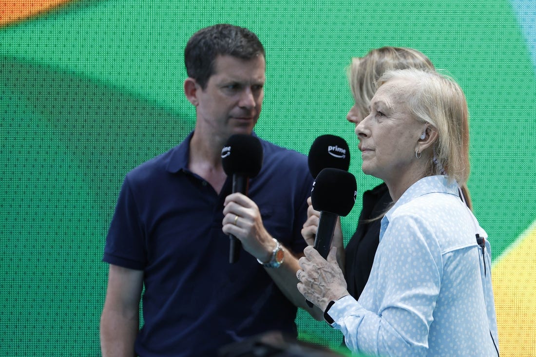 Mar 29, 2023; Miami, Florida, US; Martina Navratilova (R) does a tv hit for PrimeTV with co-presenters Tim Henman (L) and Daniela Hantuchova (M) during a stoppage between sets in the match between Sorana Cirstea (ROU)  and Aryna Sabalenka (both not pictured) in a women's singles quarterfinal on day ten of the Miami Open at Hard Rock Stadium. Mandatory Credit: Geoff Burke-USA TODAY Sports