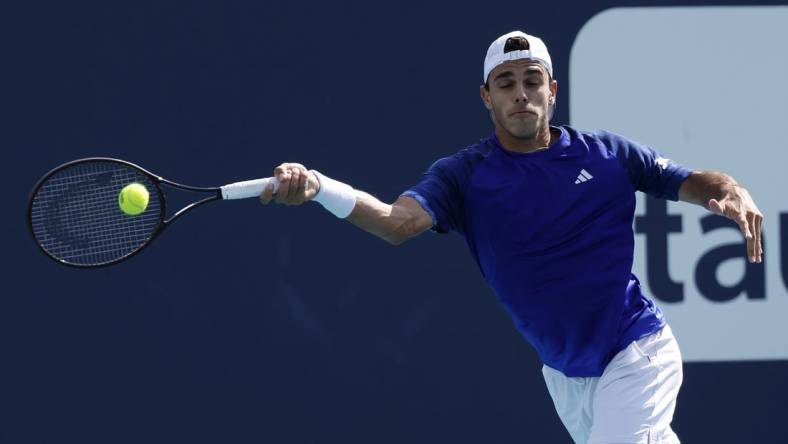 Mar 30, 2023; Miami, Florida, US; Francisco Cerundolo (ARG) hits a forehand against Karen Khachanov (not pictured) in a men's singles quarterfinal on day eleven of the Miami Open at Hard Rock Stadium. Mandatory Credit: Geoff Burke-USA TODAY Sports