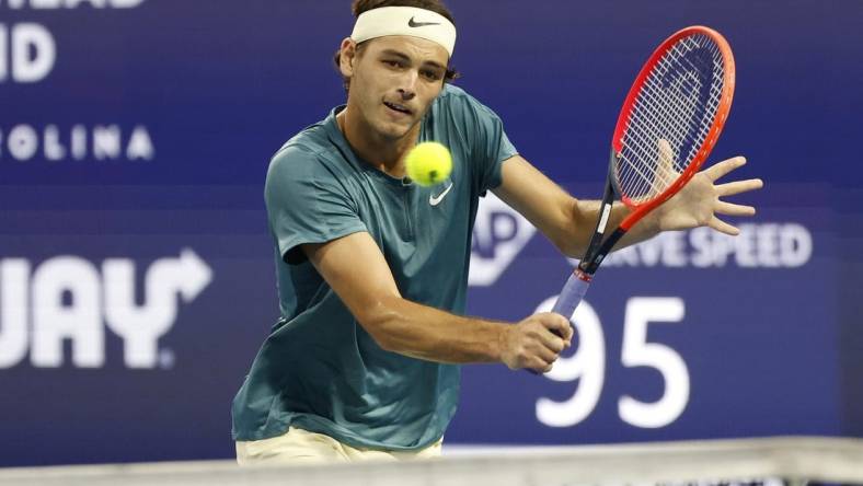 Mar 30, 2023; Miami, Florida, US; Taylor Fritz (USA) hits a volley against Carlos Alcaraz (ESP) (not pictured) in a men's singles quarterfinal on day eleven of the Miami Open at Hard Rock Stadium. Mandatory Credit: Geoff Burke-USA TODAY Sports