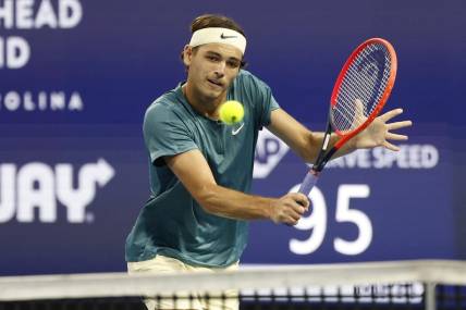 Mar 30, 2023; Miami, Florida, US; Taylor Fritz (USA) hits a volley against Carlos Alcaraz (ESP) (not pictured) in a men's singles quarterfinal on day eleven of the Miami Open at Hard Rock Stadium. Mandatory Credit: Geoff Burke-USA TODAY Sports