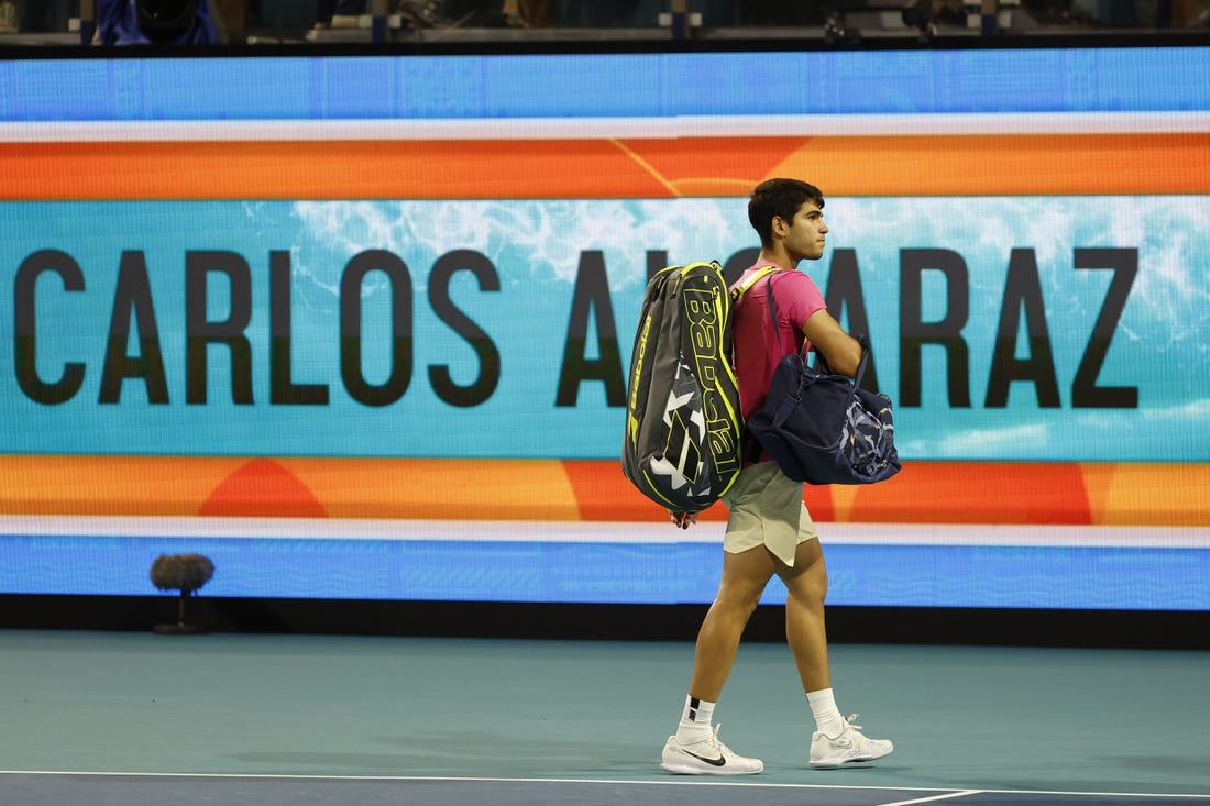 Mar 31, 2023; Miami, Florida, US; Carlos Alcaraz (ESP) waves to the crowd while leaving the court after his match against Jannik Sinner (ITA) (not pictured) in a men's singles semifinal on day twelve on the Miami Open at Hard Rock Stadium. Mandatory Credit: Geoff Burke-USA TODAY Sports