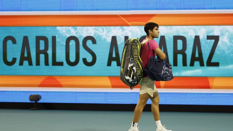 Mar 31, 2023; Miami, Florida, US; Carlos Alcaraz (ESP) waves to the crowd while leaving the court after his match against Jannik Sinner (ITA) (not pictured) in a men's singles semifinal on day twelve on the Miami Open at Hard Rock Stadium. Mandatory Credit: Geoff Burke-USA TODAY Sports