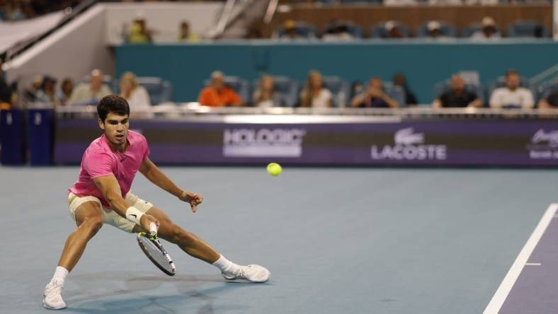 Mar 31, 2023; Miami, Florida, US; Carlos Alcaraz (ESP) reaches for a forehand against Jannik Sinner (ITA) (not pictured) in a men's singles semifinal on day twelve on the Miami Open at Hard Rock Stadium. Mandatory Credit: Geoff Burke-USA TODAY Sports