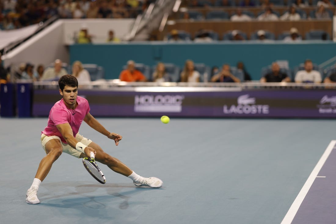 Mar 31, 2023; Miami, Florida, US; Carlos Alcaraz (ESP) reaches for a forehand against Jannik Sinner (ITA) (not pictured) in a men's singles semifinal on day twelve on the Miami Open at Hard Rock Stadium. Mandatory Credit: Geoff Burke-USA TODAY Sports