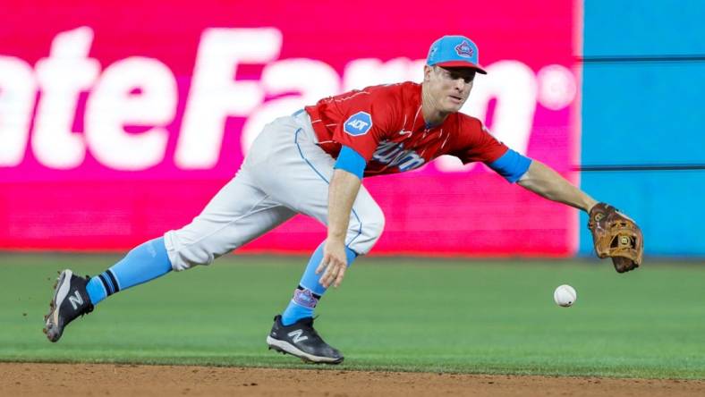 Apr 1, 2023; Miami, Florida, USA; Miami Marlins shortstop Joey Wendle (18) dives but cannot catch a base hit from New York Mets catcher Omar Narvaez (not pictured) during the eighth inning at loanDepot Park. Mandatory Credit: Sam Navarro-USA TODAY Sports