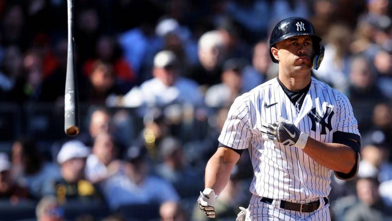 Apr 2, 2023; Bronx, New York, USA; New York Yankees designated hitter Giancarlo Stanton (27) tosses his bat after drawing a walk during the seventh inning against the San Francisco Giants at Yankee Stadium. Mandatory Credit: Brad Penner-USA TODAY Sports