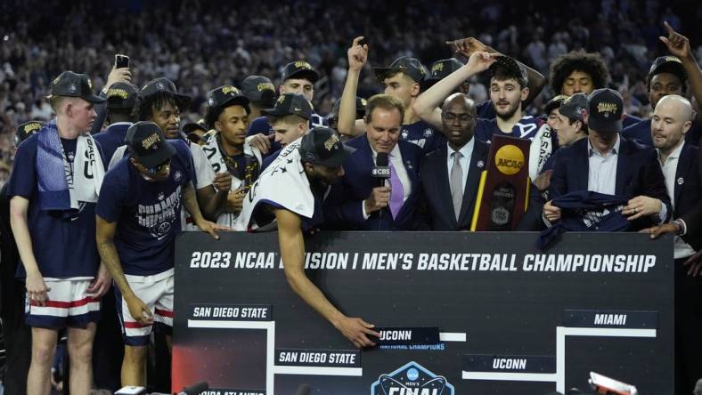 Apr 3, 2023; Houston, TX, USA; Connecticut Huskies players celebrates after defeating the San Diego State Aztecs in the national championship game of the 2023 NCAA Tournament at NRG Stadium. Mandatory Credit: Bob Donnan-USA TODAY Sports