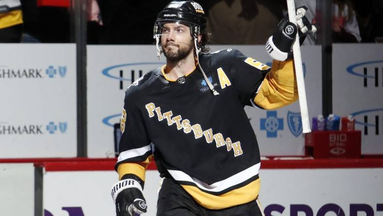 Apr 6, 2023; Pittsburgh, Pennsylvania, USA; Pittsburgh Penguins defenseman Kris Letang (58) to the crowd reacts after being named first star of the game and defeating the Minnesota Wild at PPG Paints Arena. Pittsburgh won 4-1. Mandatory Credit: Charles LeClaire-USA TODAY Sports