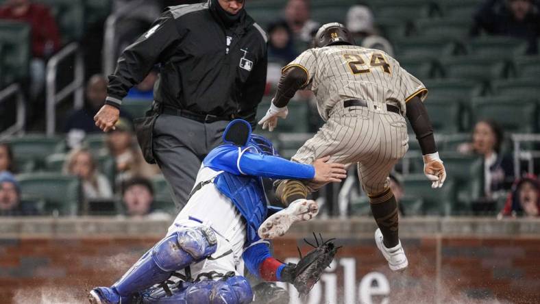 Apr 8, 2023; Cumberland, Georgia, USA; San Diego Padres right fielder Rougned Odor (24) is tagged out on a collision with Atlanta Braves catcher Travis d'Arnaud (16) during the fourth inning  at Truist Park. Mandatory Credit: Dale Zanine-USA TODAY Sports