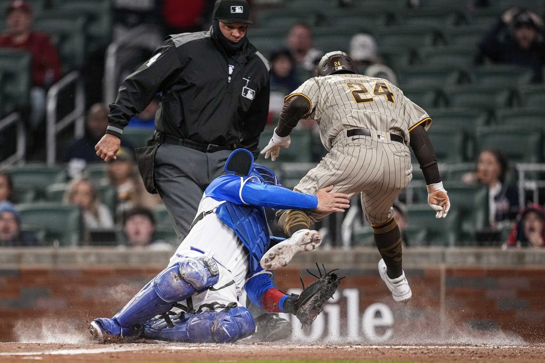 Apr 8, 2023; Cumberland, Georgia, USA; San Diego Padres right fielder Rougned Odor (24) is tagged out on a collision with Atlanta Braves catcher Travis d'Arnaud (16) during the fourth inning  at Truist Park. Mandatory Credit: Dale Zanine-USA TODAY Sports