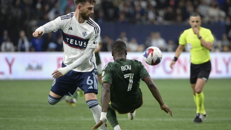 Apr 8, 2023; Vancouver, British Columbia, CAN;  Vancouver Whitecaps FC defender Tristan Blackmon (6) battles for the ball against Portland Timbers forward Franck Boli (7) during the second half at BC Place. Mandatory Credit: Anne-Marie Sorvin-USA TODAY Sports