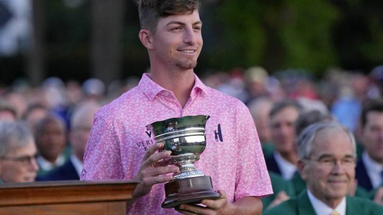 Apr 9, 2023; Augusta, Georgia, USA; Sam Bennett holds the low amateur trophy after the final round of The Masters golf tournament. Mandatory Credit: Michael Madrid-USA TODAY Network