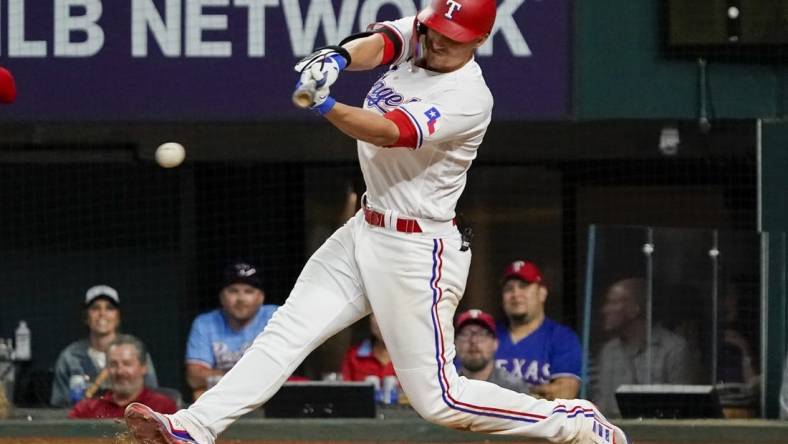 Apr 10, 2023; Arlington, Texas, USA;  Texas Rangers shortstop Corey Seager (5) hits a single during the eighth inning against the Kansas City Royals at Globe Life Field. Mandatory Credit: Raymond Carlin III-USA TODAY Sports