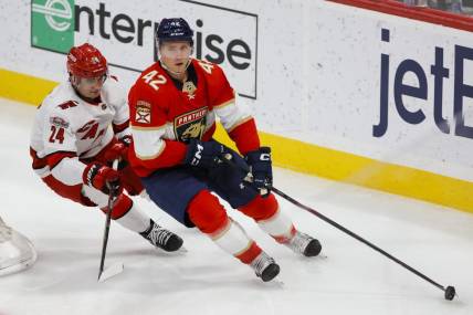 Apr 13, 2023; Sunrise, Florida, USA; Florida Panthers defenseman Gustav Forsling (42) moves the puck ahead of Carolina Hurricanes center Seth Jarvis (24) during the second period at FLA Live Arena. Mandatory Credit: Sam Navarro-USA TODAY Sports