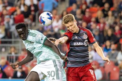 Apr 15, 2023; Toronto, Ontario, CAN;  Atlanta United forward Machop Chol (30) heads the ball before scoring against Toronto FC during the second half at BMO Field. Mandatory Credit: Kevin Sousa-USA TODAY Sports